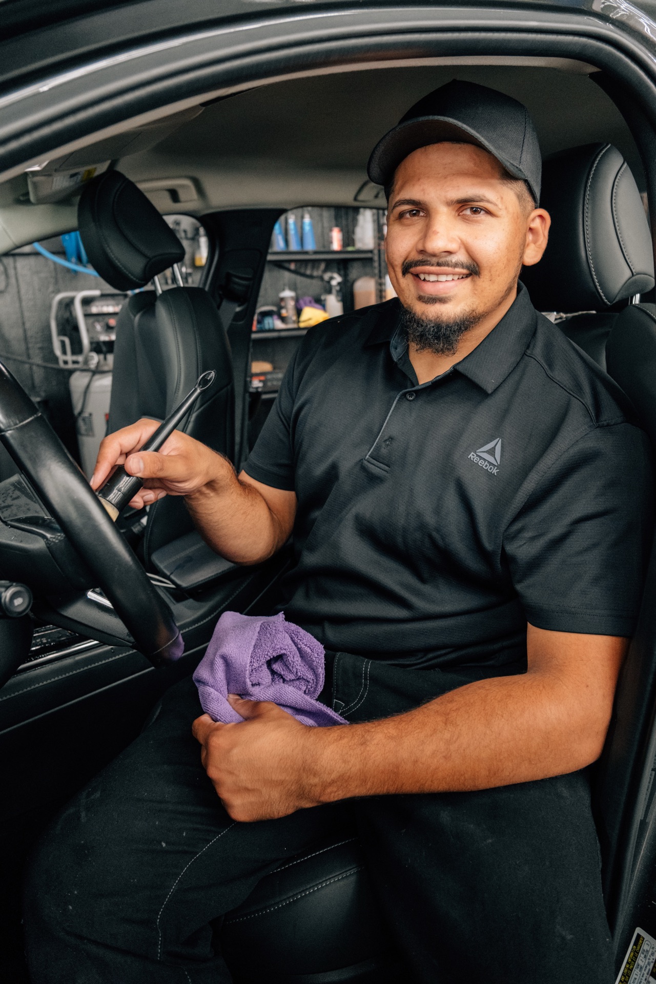 Detailing a car interior with a brush at Moody's Extreme Detailing