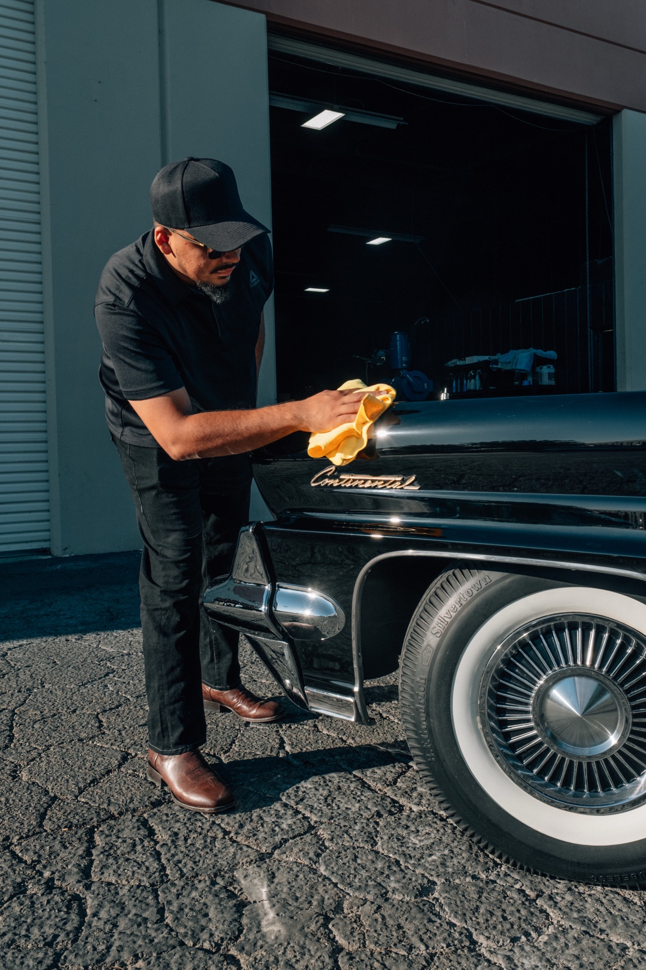 Wiping down a classic Lincoln Continental at golden hour