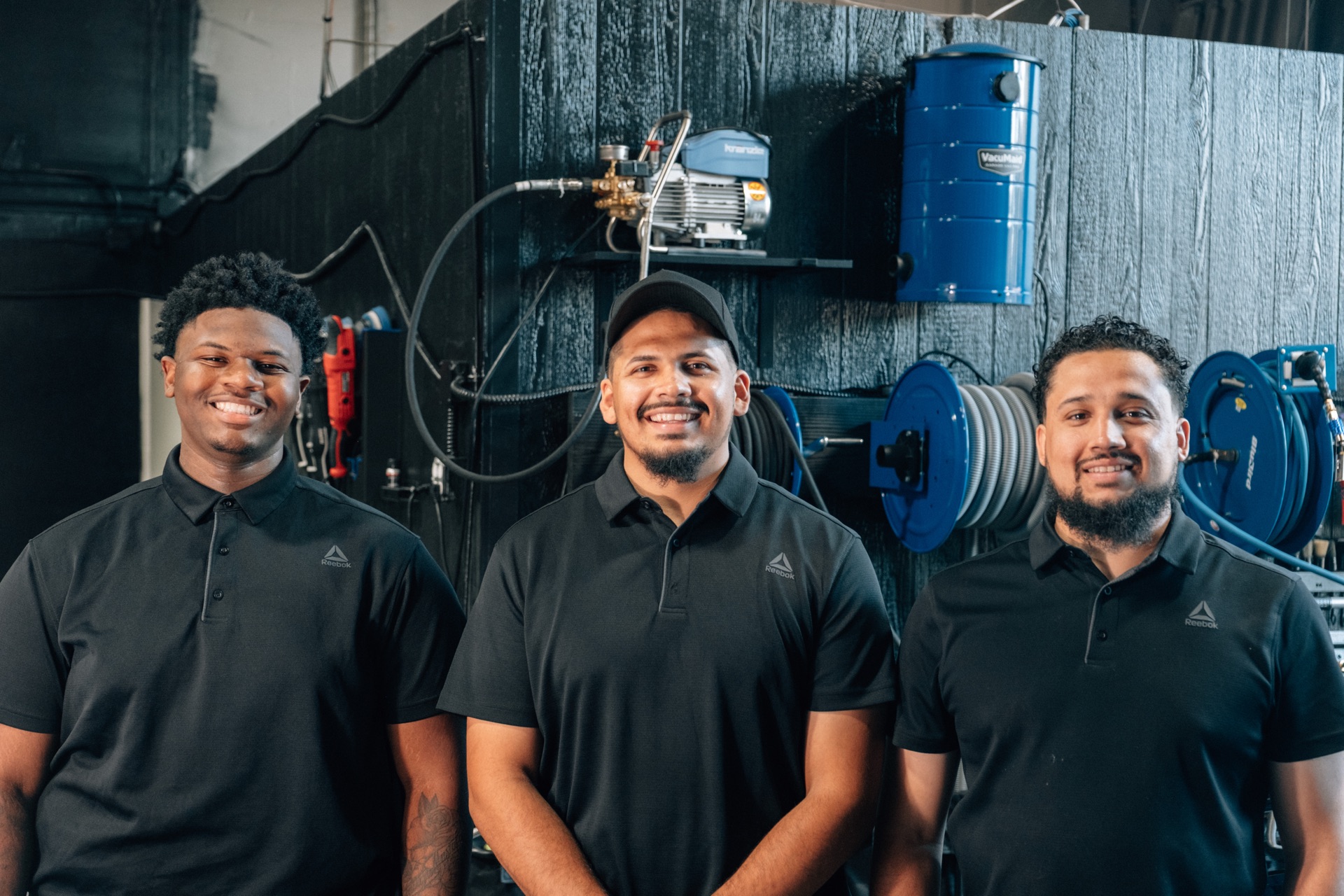 Moody's Extreme Detailing crew smiling inside the shop